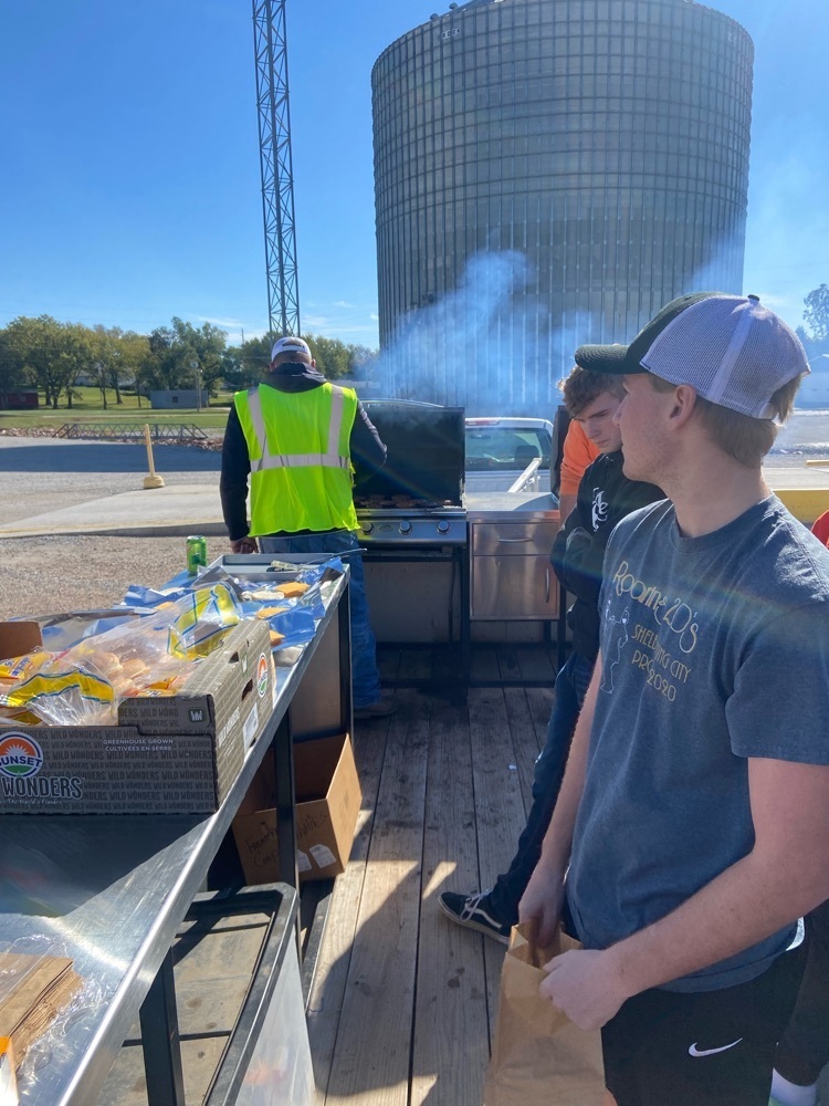 Ian Novak and Jacob Sandman wait to hand out meals to hungry farmers. photo credit to Braxton Mestl