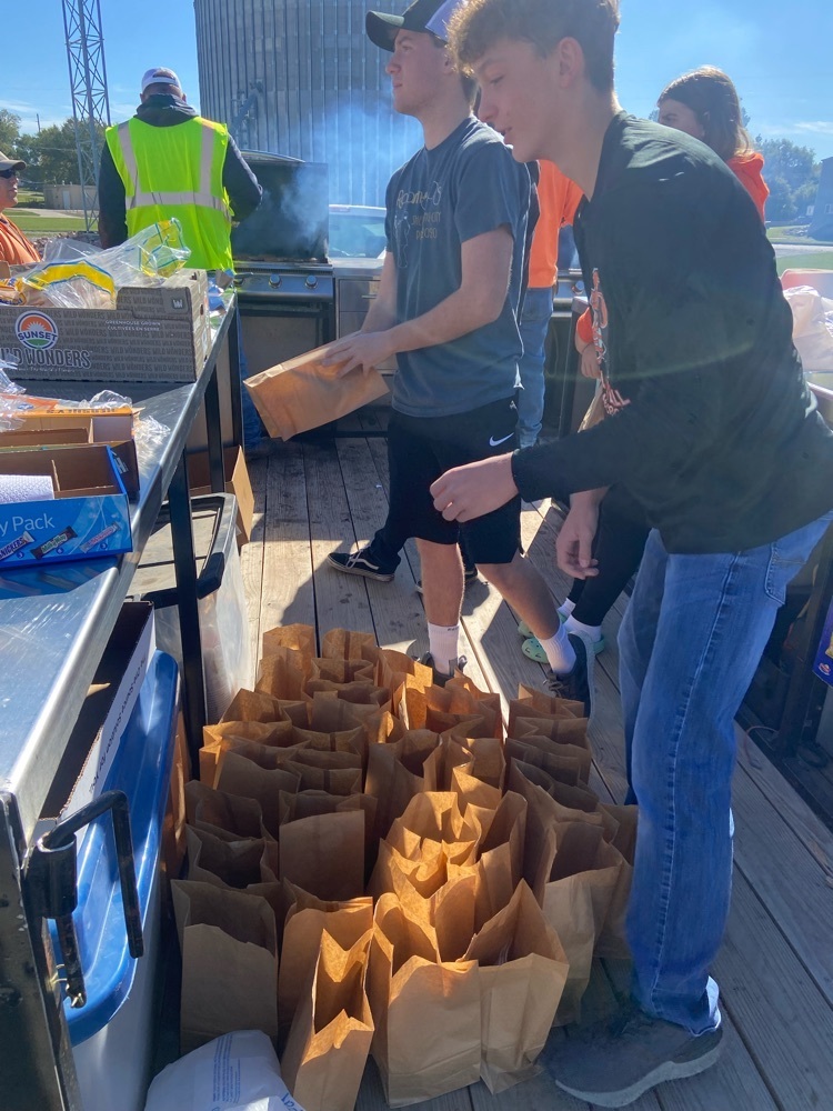 Kolton Neujahr serving farmers at the Coops Feed the Farmer event. photo credit to Braxton Mestl